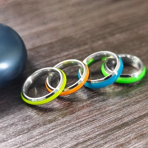 Glow in the dark stainless steel ring set in four vibrant fluorescent colors