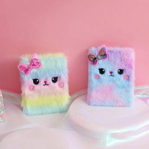 Detail of plush cat journals featuring rainbow and tie-dye fur with sequin bows