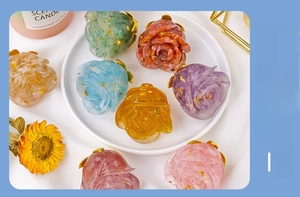 Detail of colorful resin roses with natural crystal chips and gold foil flakes