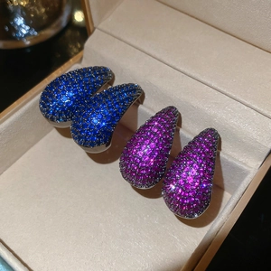 Sparkling teardrop stud earrings with blue and purple cubic zirconia in a jewelry box
