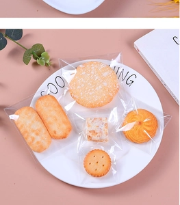 Close-up of assorted cookies and snacks in transparent heat-sealed packaging bags