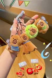 Close-up of plush capybara keychains with tennis and sporty outfits and metal bead chains