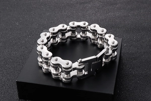 Macro shot of silver motorcycle chain bracelet with folding clasp on black stand