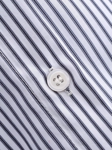 Detailed close-up of blue and white striped poplin shirt with high-quality white button