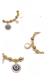 Macro detail of 18K gold-plated titanium steel evil eye and heart charm bracelet