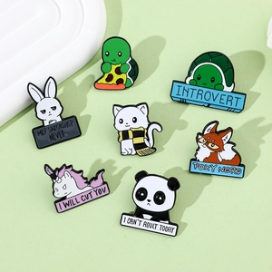 Detailed view of assorted cartoon animal metal pins with funny English phrases on light green
