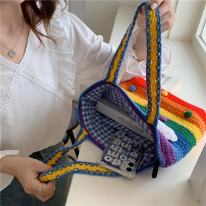 Spacious rainbow knit tote bag showing inner lining and room for books and a phone