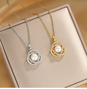 Detail of gold and silver camellia necklaces with pearls and zircons in a jewelry box
