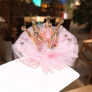 Detail of pink mesh crown hair clip with gold metal and sparkling rhinestones
