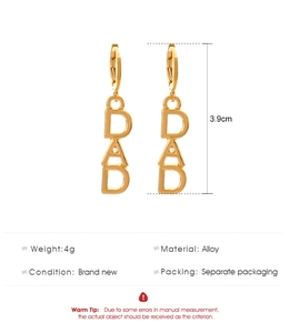 Detail of gold-colored DAD letter earrings showing 3.9cm height and alloy texture
