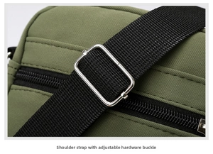 Detail of adjustable silver metal buckle and black nylon shoulder strap on green bag