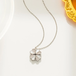 Versatile clover heart necklace with white shell inlay and silver chain on white background