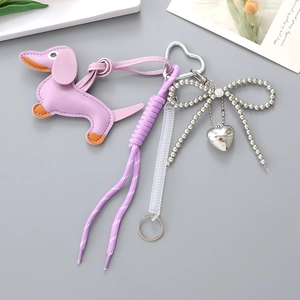 Detail of purple leather dachshund charm with woven rope and silver beaded bow decoration