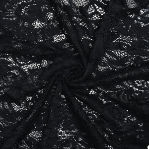 Macro detail of high-quality black floral lace fabric with intricate mesh patterns