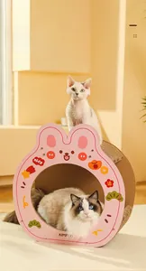 Detail of a rabbit-shaped pink cardboard cat house showing the sturdy double-layer structure