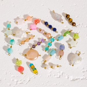 Flat lay of colorful natural stones, baroque pearls and shell beads for DIY jewelry making