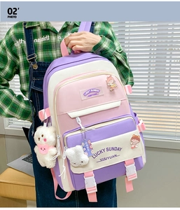 Close-up of color-block backpack with Lucky Sunday tag and white plush rabbit charm
