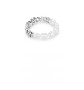 Macro view of Baroque pearls and silver spiral band detail on a minimalist stretch ring