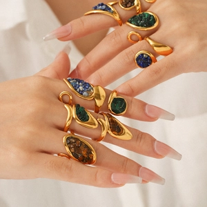 Vintage gold-plated stainless steel rings with natural stone inlays on hand