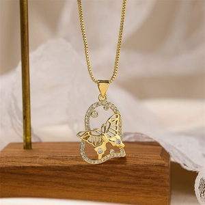 Macro shot of a gold heart pendant with crystal butterfly on a wooden display