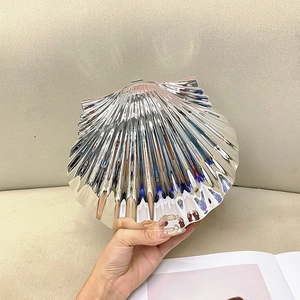 Detailed view of silver shell evening clutch with radial textures and metal finish