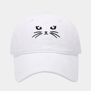 Close-up of cute black cat embroidery on a white cotton baseball cap with fine texture