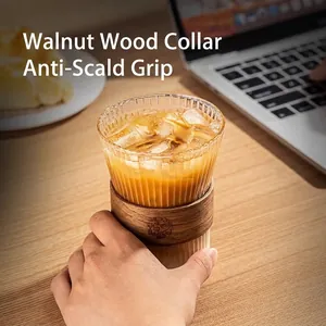 Minimalist vertical stripe glass coffee cup featuring a walnut wood heat insulation sleeve