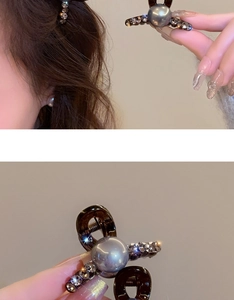 Close-up of a bow-shaped hair claw clip with a large central pearl and sparkling rhinestones