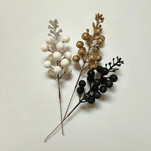Close-up of gold, white and black artificial Christmas berry stems for DIY crafts