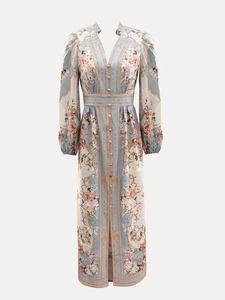 Detail of elegant V-neck floral print maxi dress with baroque patterns and button-up front