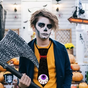 Boy in skull makeup wearing a black Halloween tie with red blood and purple eyeball design