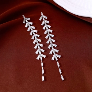 Detail view of silver leaf tassel earrings with sparkling cubic zirconia on velvet