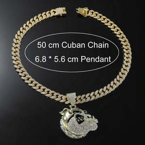 Detail of 50cm gold Cuban chain with iced-out bulldog pendant on black surface
