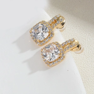 Macro shot of gold square zircon earrings with French vintage pave diamond detailing