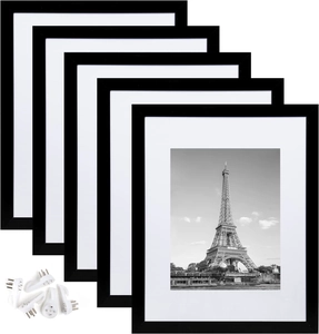 Detail of 5 black minimalist 14-inch photo frames with white matting and mounting nails