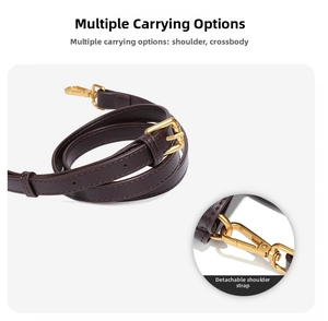 Detail of adjustable dark brown leather shoulder strap with golden metal swivel hooks