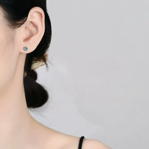 S925 sterling silver moissanite stud earrings featuring a classic six-prong setting on ear
