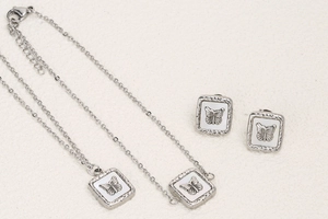 Detailed close-up of a butterfly jewelry set featuring a necklace, bracelet, and earrings