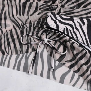 Detail of zebra print mesh fabric with drawstring and tie accents on bikini beachwear