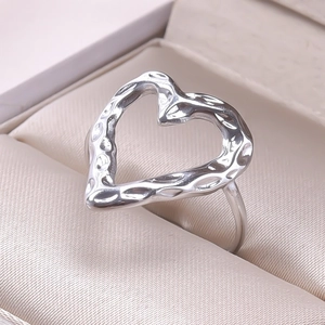 Detail of silver heart-shaped ring with hammered texture in jewelry box display