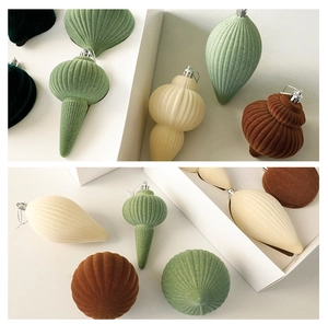 Detailed view of textured flocked Christmas ornaments in neutral Morandi tones