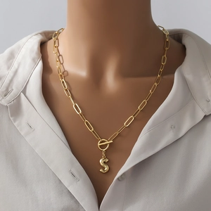 Gold plated hip hop necklace with alphabet S pendant and T-bar clasp on a model