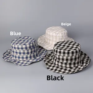 Detailed view of plaid linen bucket hats in blue, beige, and black for sun protection