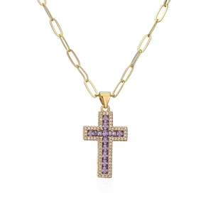 Detail of 18K gold paperclip chain necklace featuring a purple zircon cross pendant