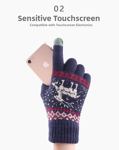 Navy knit touchscreen gloves with reindeer pattern showing phone use on white background