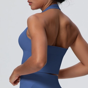 Macro detail of the seamless blue halter neck sports bra showing back design and elastic fabric