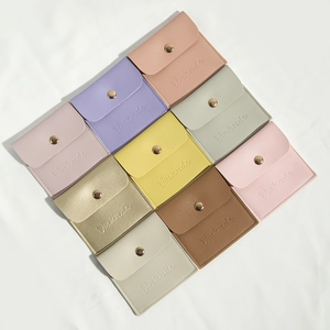 PU leather jewelry pouches with metal snaps in various macaron colors on white cloth