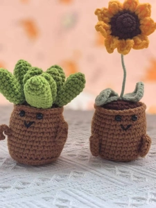 Detailed view of handmade crochet succulents and sunflower dolls in miniature pots