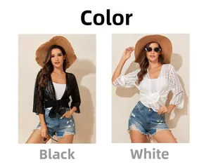 Detail of crochet hollow knit beach cover-ups in black and white colors with lace-up front