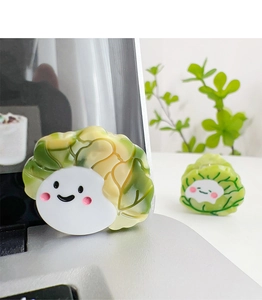 Detailed close-up of cute cartoon cabbage hair clips in green and white acetate material